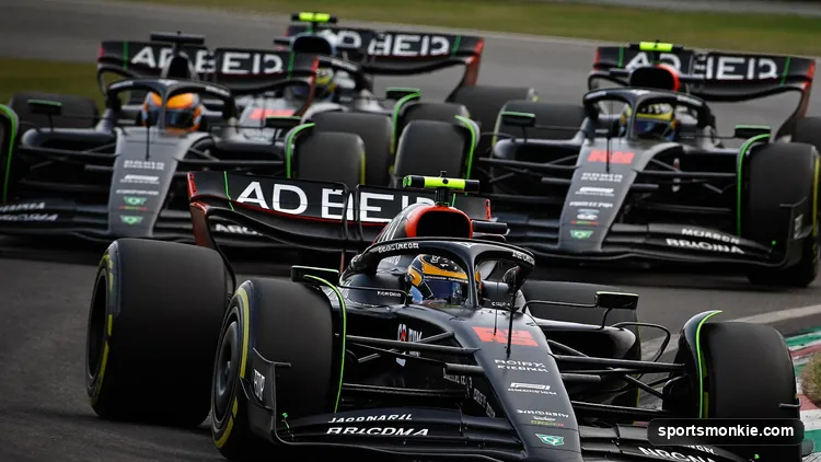 A line of Formula 1 cars running nose to tail down a straight in a DRS train