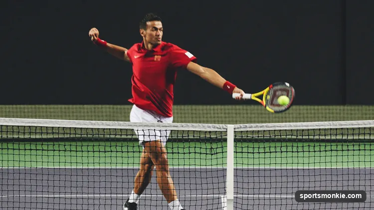 Tennis player at the net punching a forehand volley with a continental grip and short backswing