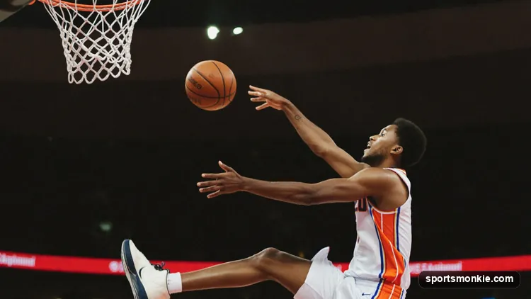 NBA player catching a lob pass above the rim to finish an alley-oop dunk