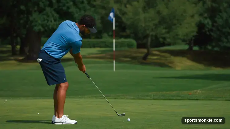 A golfer holing out from the fairway on a par 5 to card an eagle, two under par on the hole
