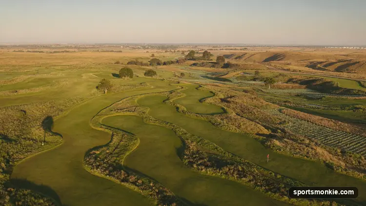 Wide view of a historic Scottish links golf course under an open sky
