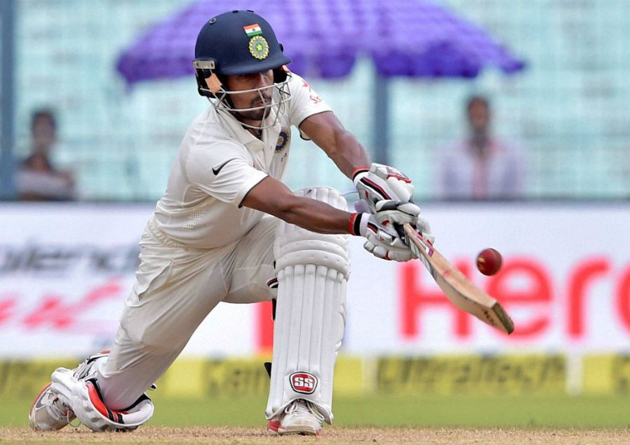 Indian batsman Wriddhiman Saha playing a sweep shot.
