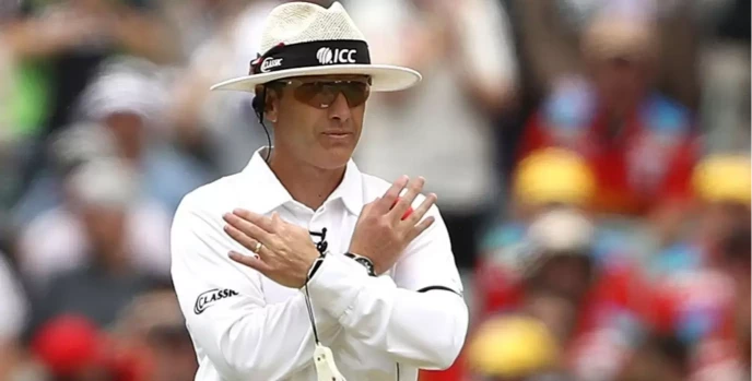 cricket umpire giving sign for not out.